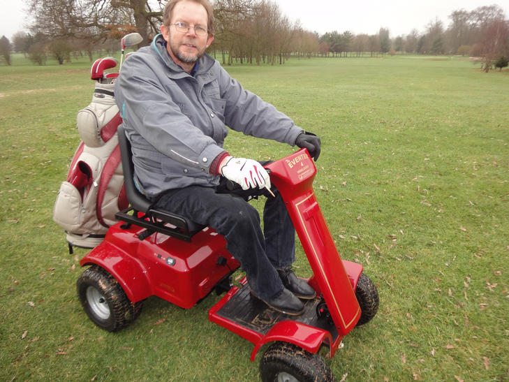 A player seated on the Patterson Eventer buggy on the fairway with the golf bag mounted at the rear